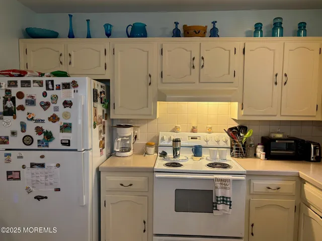 a view of a kitchen with appliances and cabinets