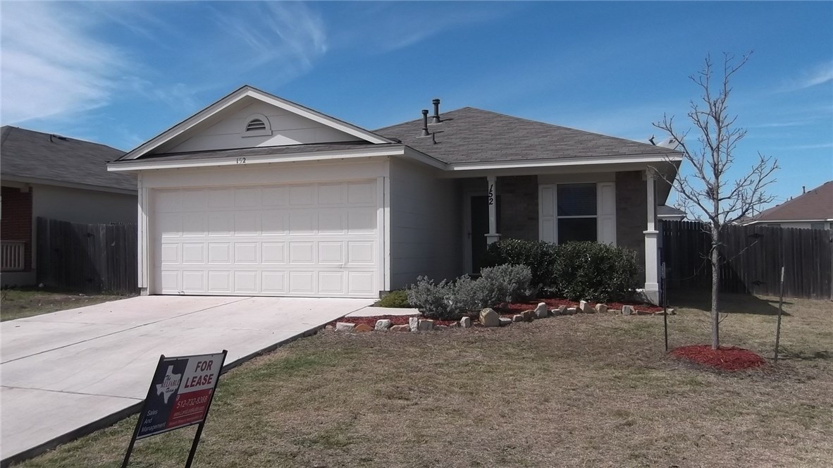 152 Challenger Kyle, TX 78640 - Photo 1 of 1 a front view of a house with a yard