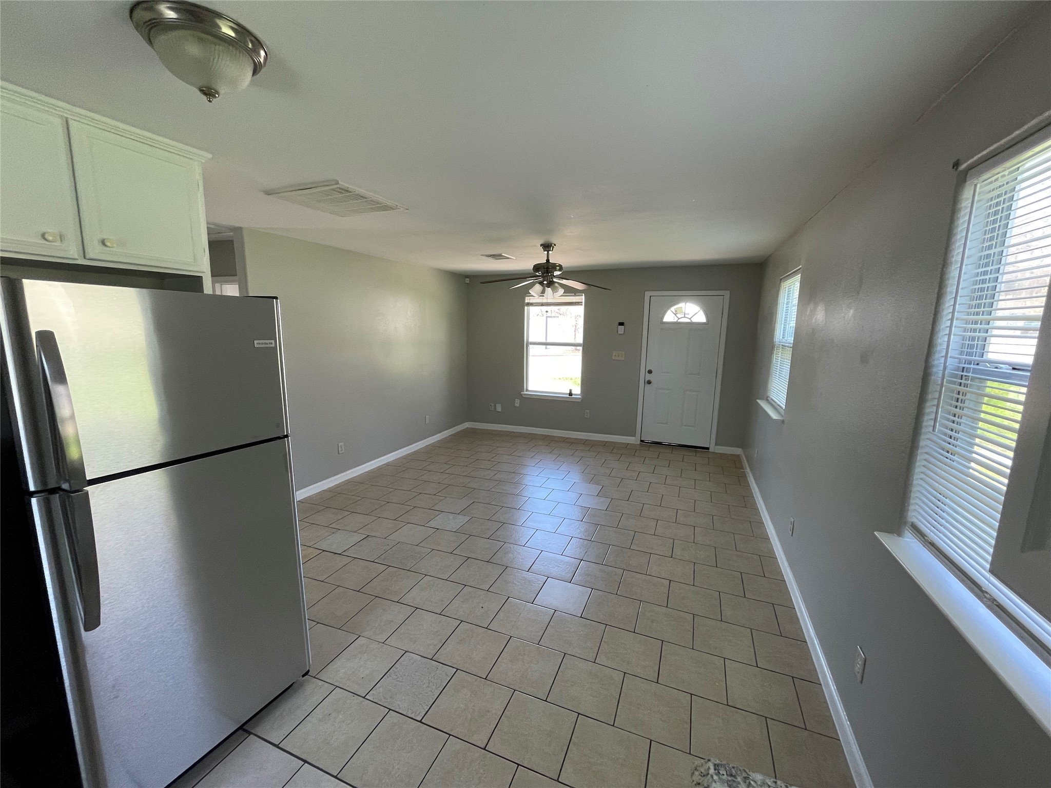 1041 Lott Avenue Austin, TX 78721 - Photo 3 of 14 a view of a refrigerator in kitchen and an empty room