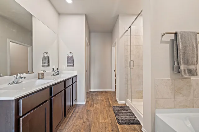a bathroom with a double vanity sink and mirror