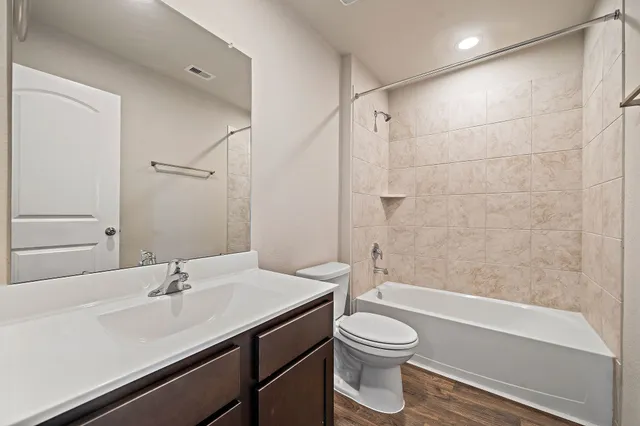 a bathroom with a sink a toilet and a bathtub