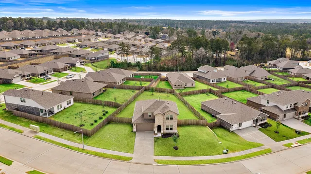 an aerial view of residential houses with outdoor space and city view