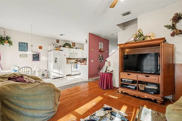 a bedroom with furniture and a flat screen tv