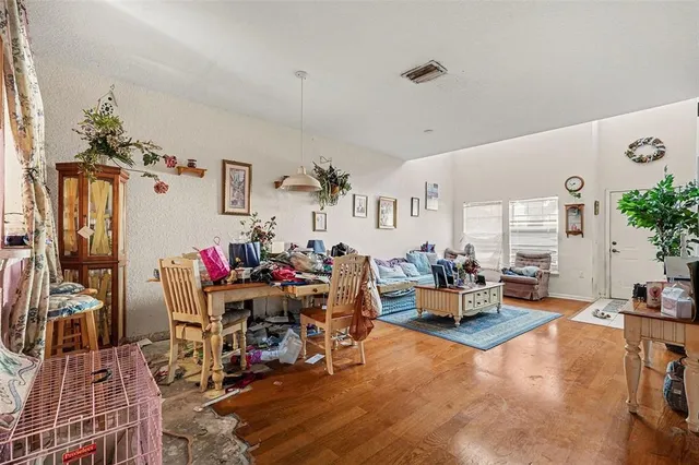 a living room with furniture and wooden floor
