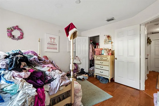 a bedroom with furniture and a closet