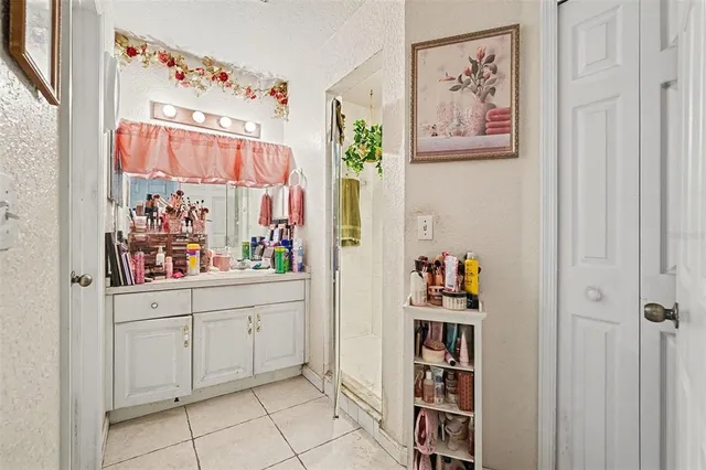 a room with painting on the wall and a window