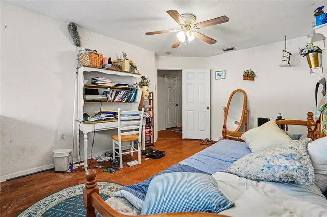 a bedroom with furniture and a wooden floor