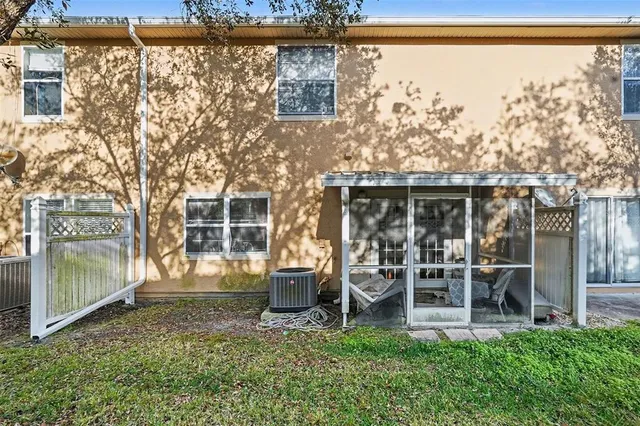 a backyard of a house with table and chairs