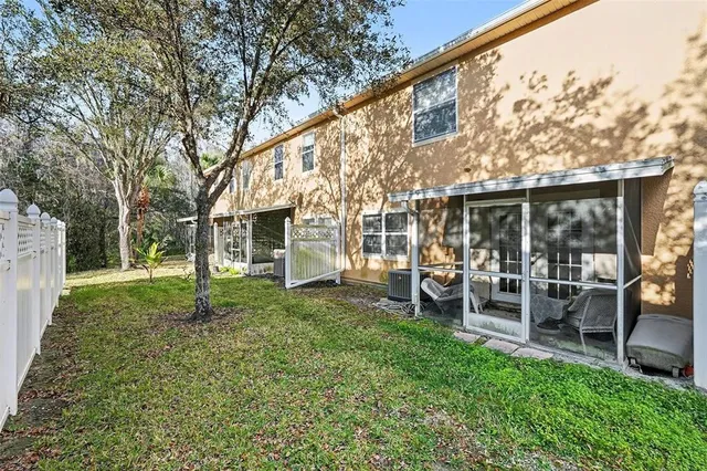a view of a house with backyard porch and sitting area