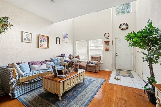 a living room with patio furniture and a potted plant