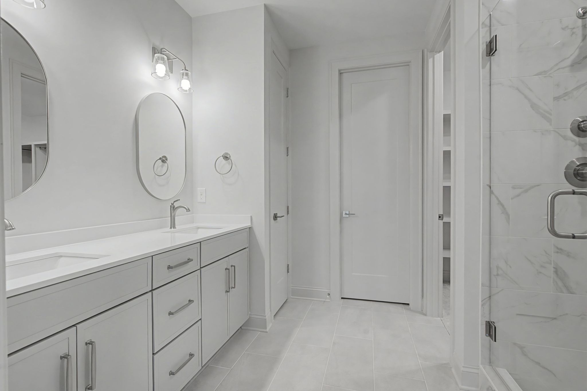 7032 Kinderhook Road Nashville, TN 37221 - Photo 42 of 91 a spacious bathroom with double vanity a sink and a mirror