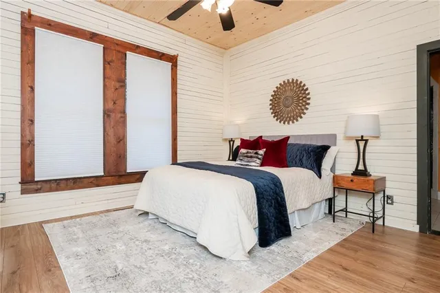 a bathroom with a granite countertop sink a large mirror and a bathtub
