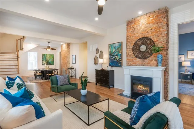 a living room with furniture a fireplace and a large window