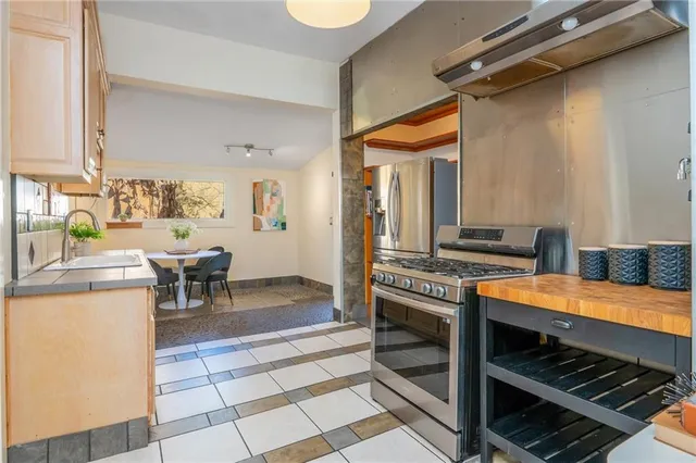 a kitchen view with a stove and a wooden floor