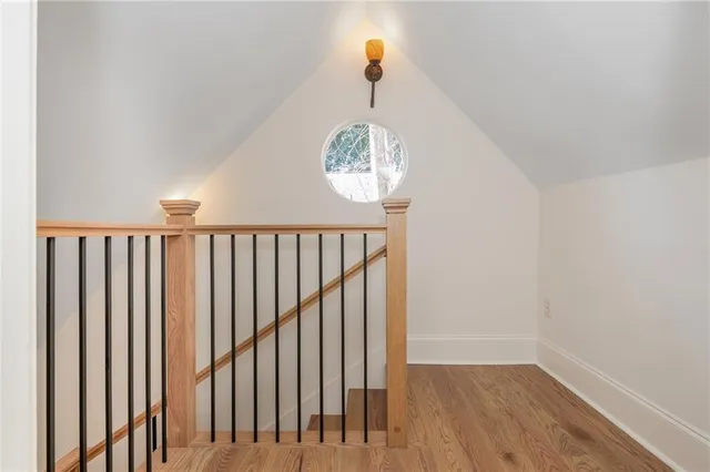 a view of wooden house with a yard and large tree