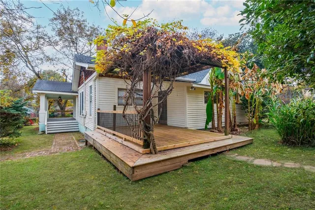 a kitchen with stainless steel appliances granite countertop wooden cabinets a stove a sink and a window