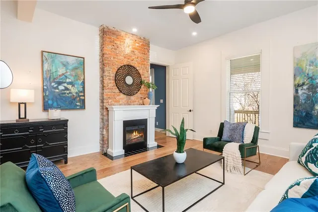 a living room with furniture and a wooden floor