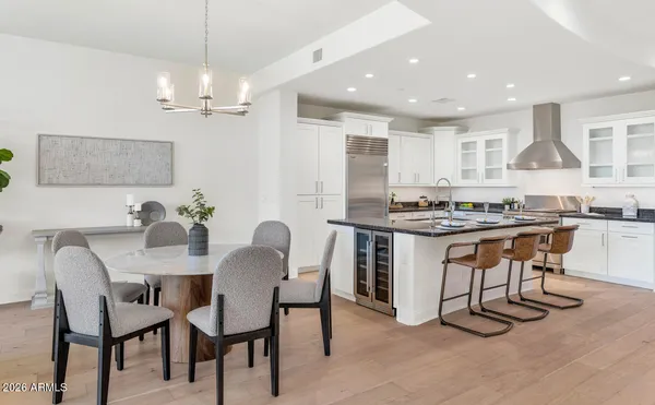 a kitchen with kitchen island granite countertop a sink stove and refrigerator