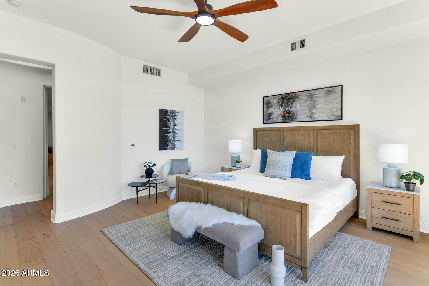 8 Biltmore Estate, Unit 209 Phoenix, AZ 85016 - Photo 23 of 49 a bedroom with a bed and wooden floor