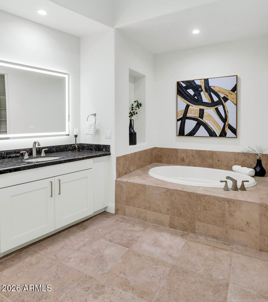 8 Biltmore Estate, Unit 209 Phoenix, AZ 85016 - Photo 26 of 49 a spacious bathroom with a bathtub and a sink