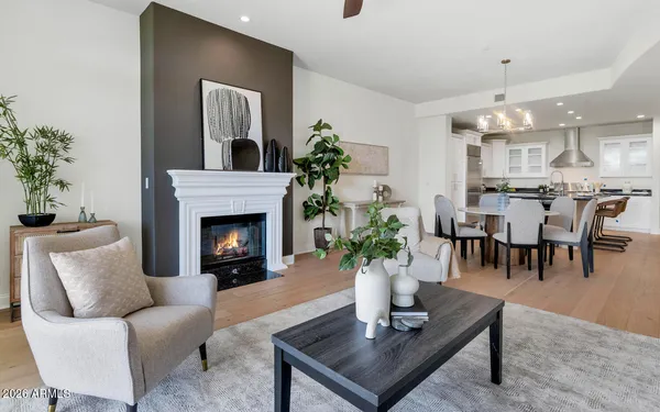a living room with furniture fireplace and a large window