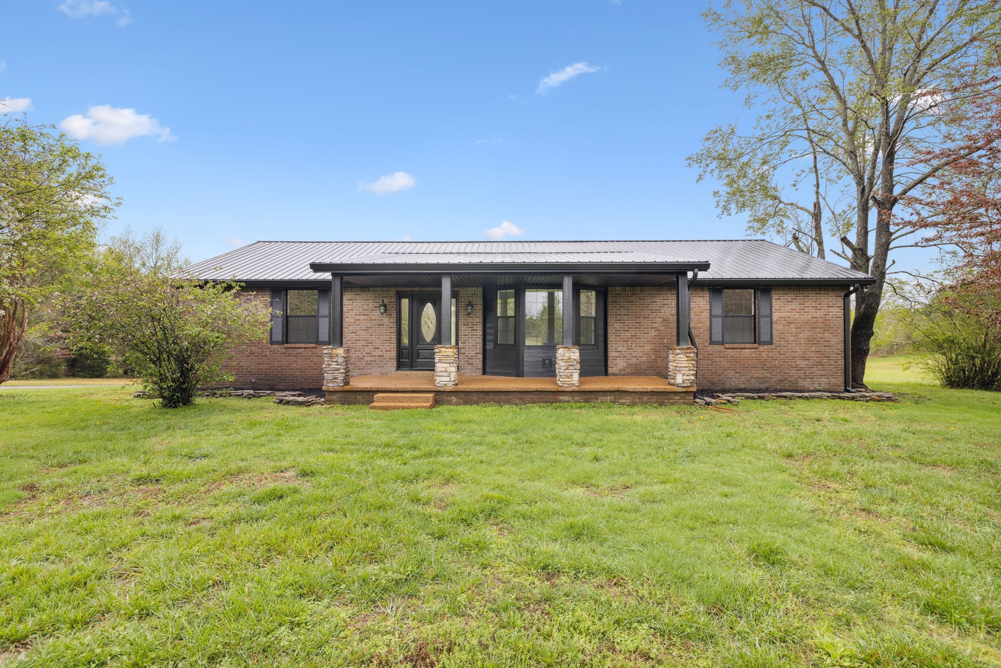 a front view of a house with a garden