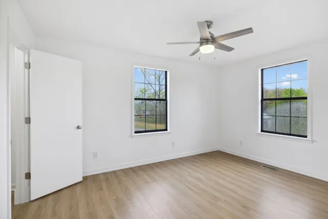 wooden floor in an empty room with a window