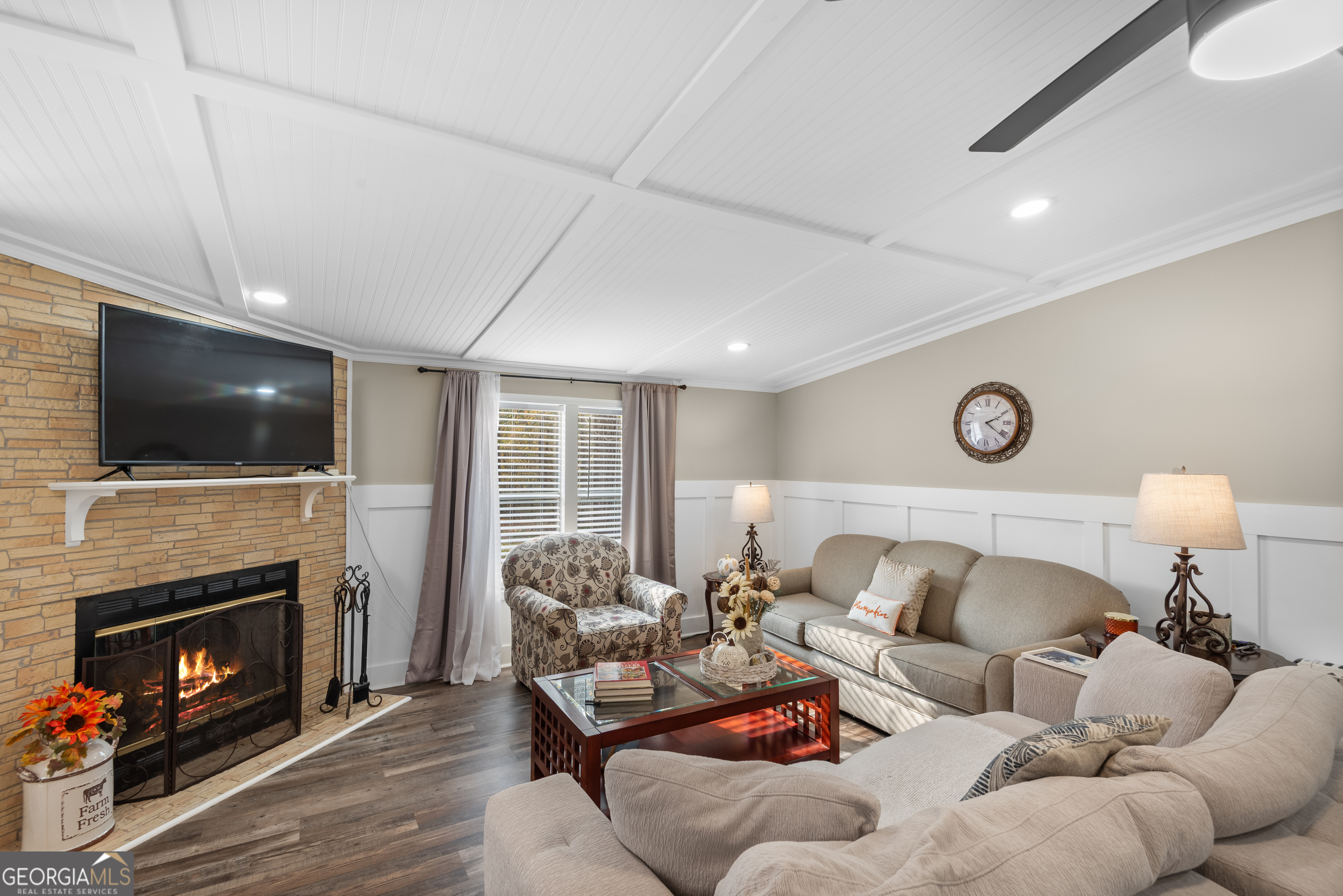 1706 Stark Road Jackson, GA 30233 - Photo 11 of 38 a living room with furniture a flat screen tv and a fireplace