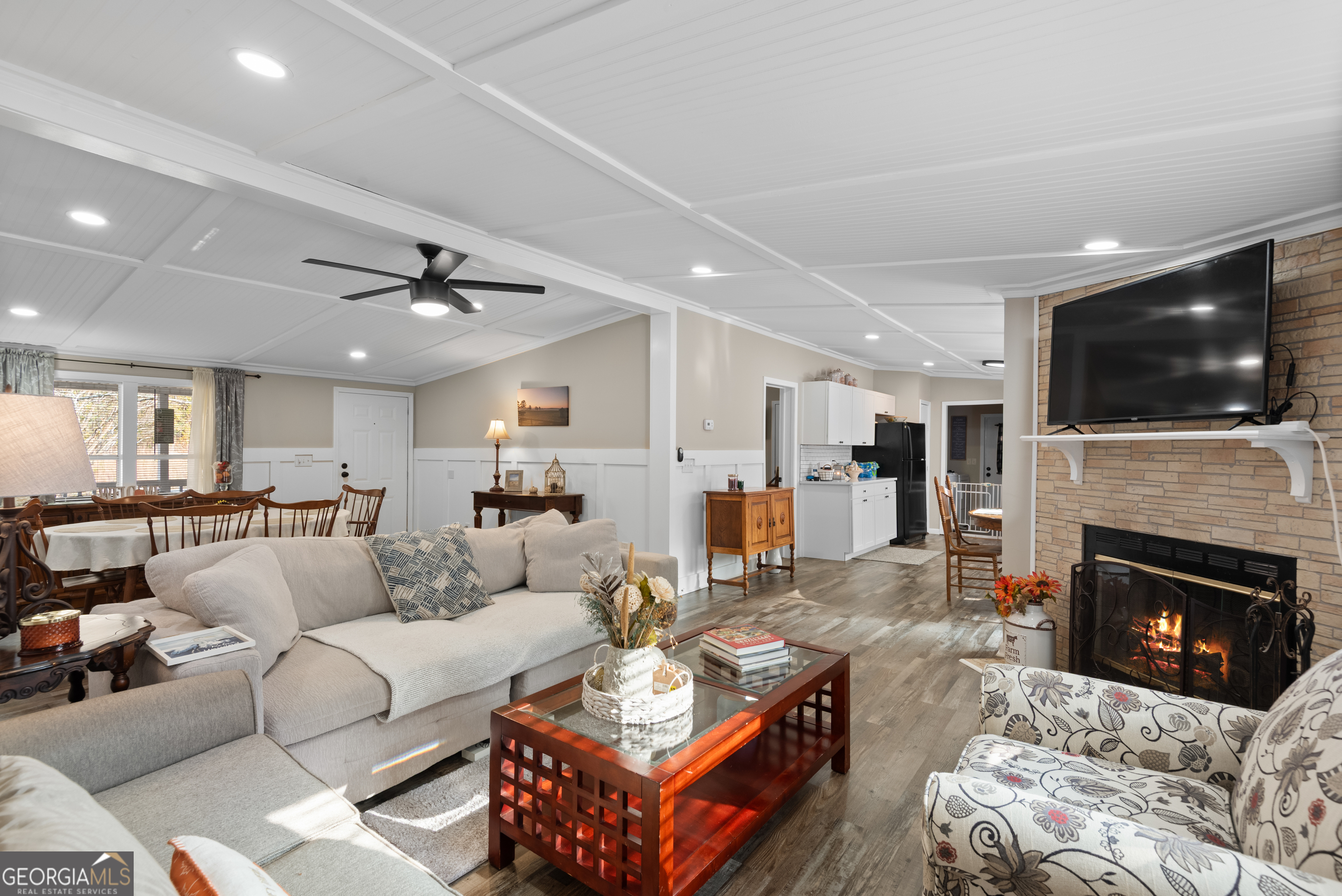 1706 Stark Road Jackson, GA 30233 - Photo 12 of 38 a living room with furniture a fireplace and a flat screen tv