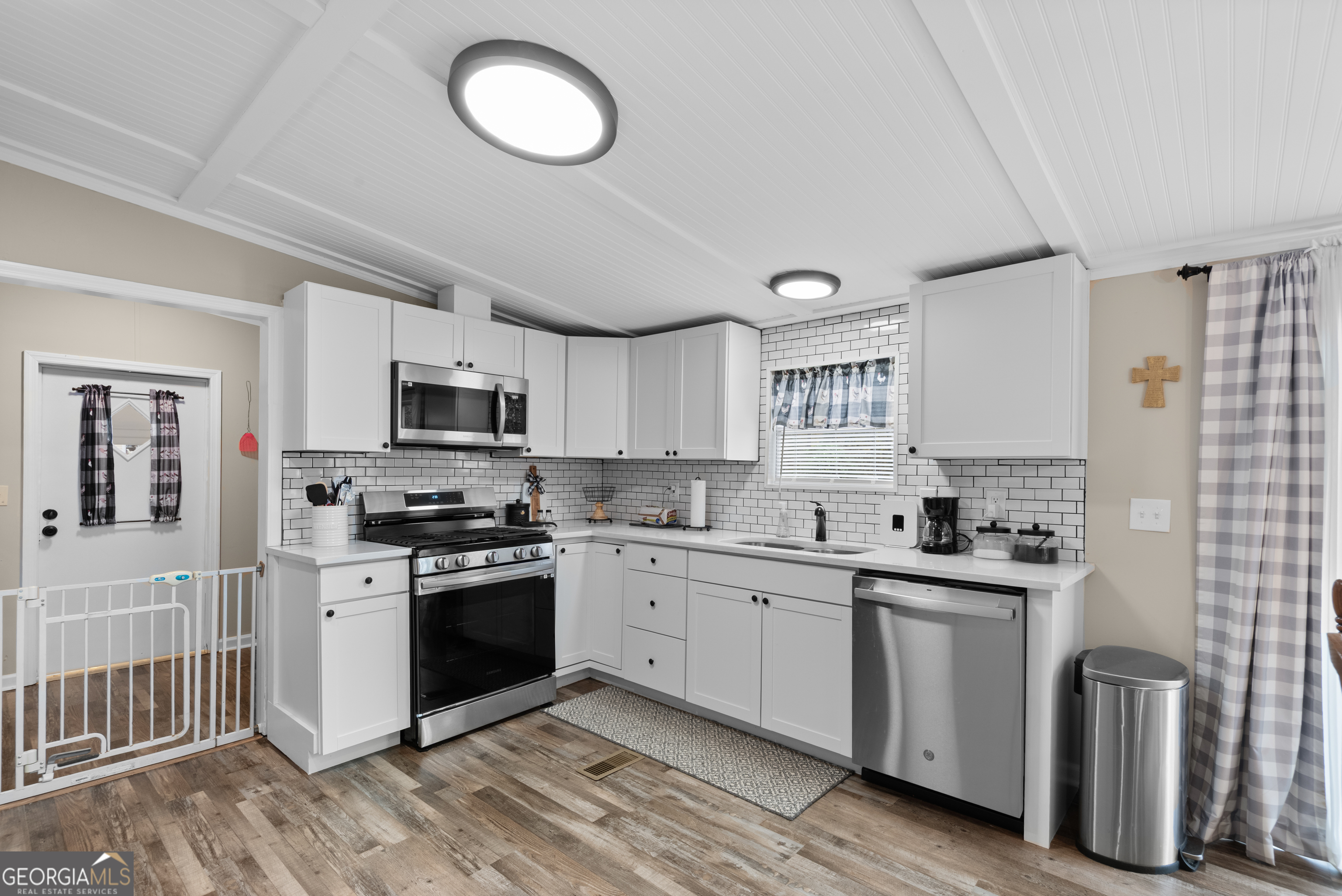 1706 Stark Road Jackson, GA 30233 - Photo 16 of 38 a kitchen with a sink stove and cabinets