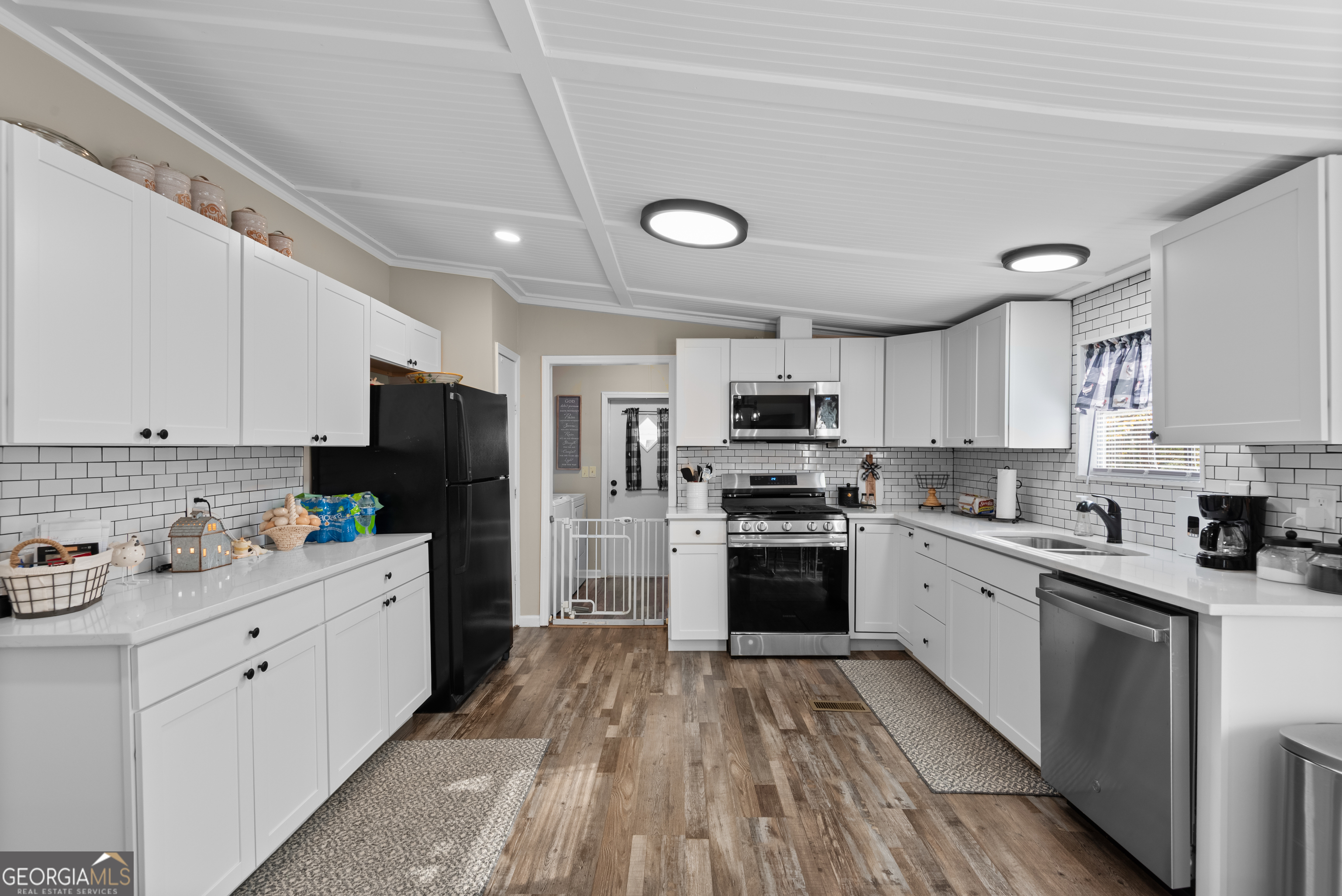 1706 Stark Road Jackson, GA 30233 - Photo 18 of 38 a kitchen with stainless steel appliances a stove refrigerator sink and cabinets