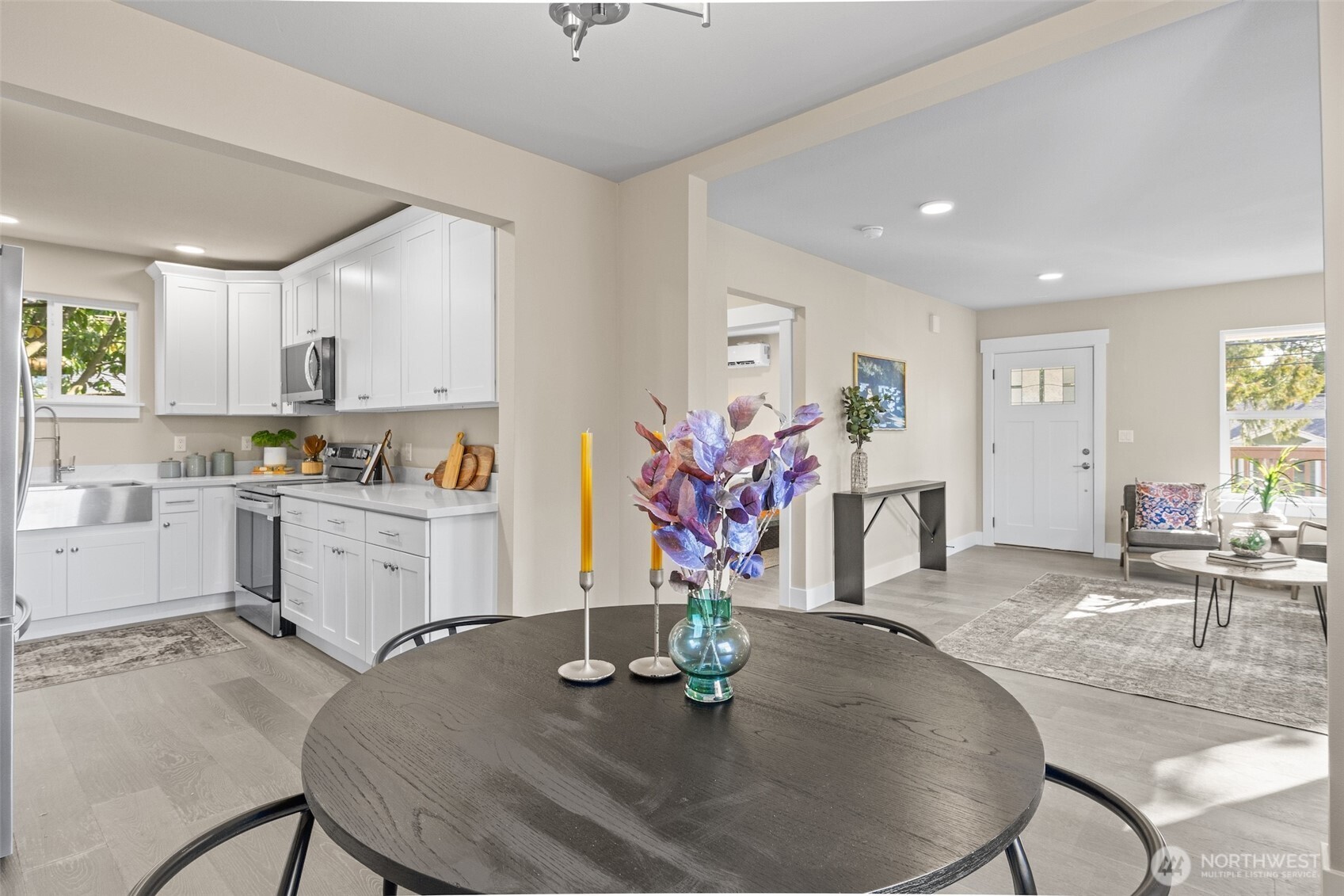 9547 Wallingford Avenue North Seattle, WA 98103 - Photo 11 of 39 a kitchen with stainless steel appliances granite countertop sink stove refrigerator and dining table
