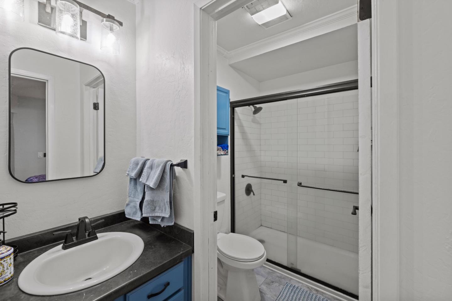 125 Surf Way, Unit 305 Monterey, CA 93940 - Photo 11 of 27 a bathroom with a sink toilet and shower
