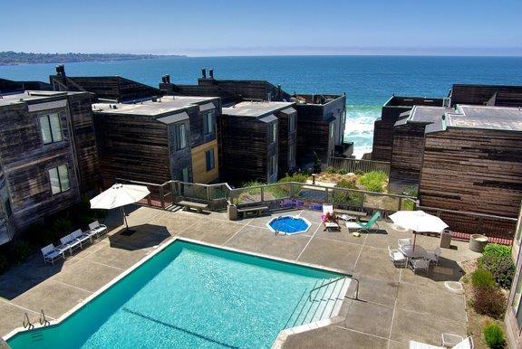 125 Surf Way, Unit 305 Monterey, CA 93940 - Photo 15 of 27 a backyard of a house with table and chairs