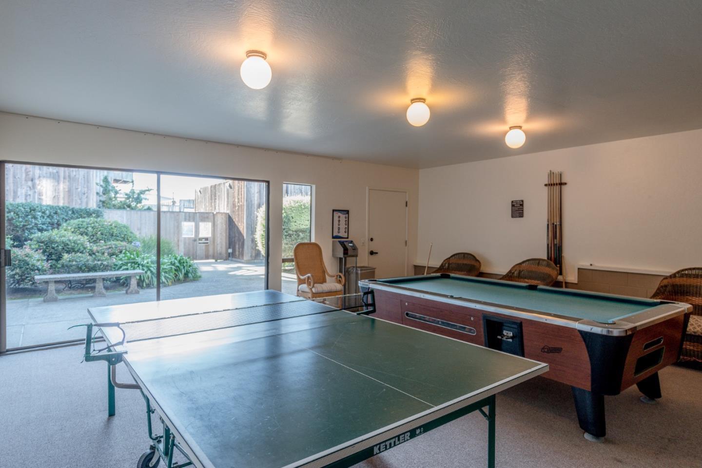 125 Surf Way, Unit 305 Monterey, CA 93940 - Photo 18 of 27 a room with pool table and windows