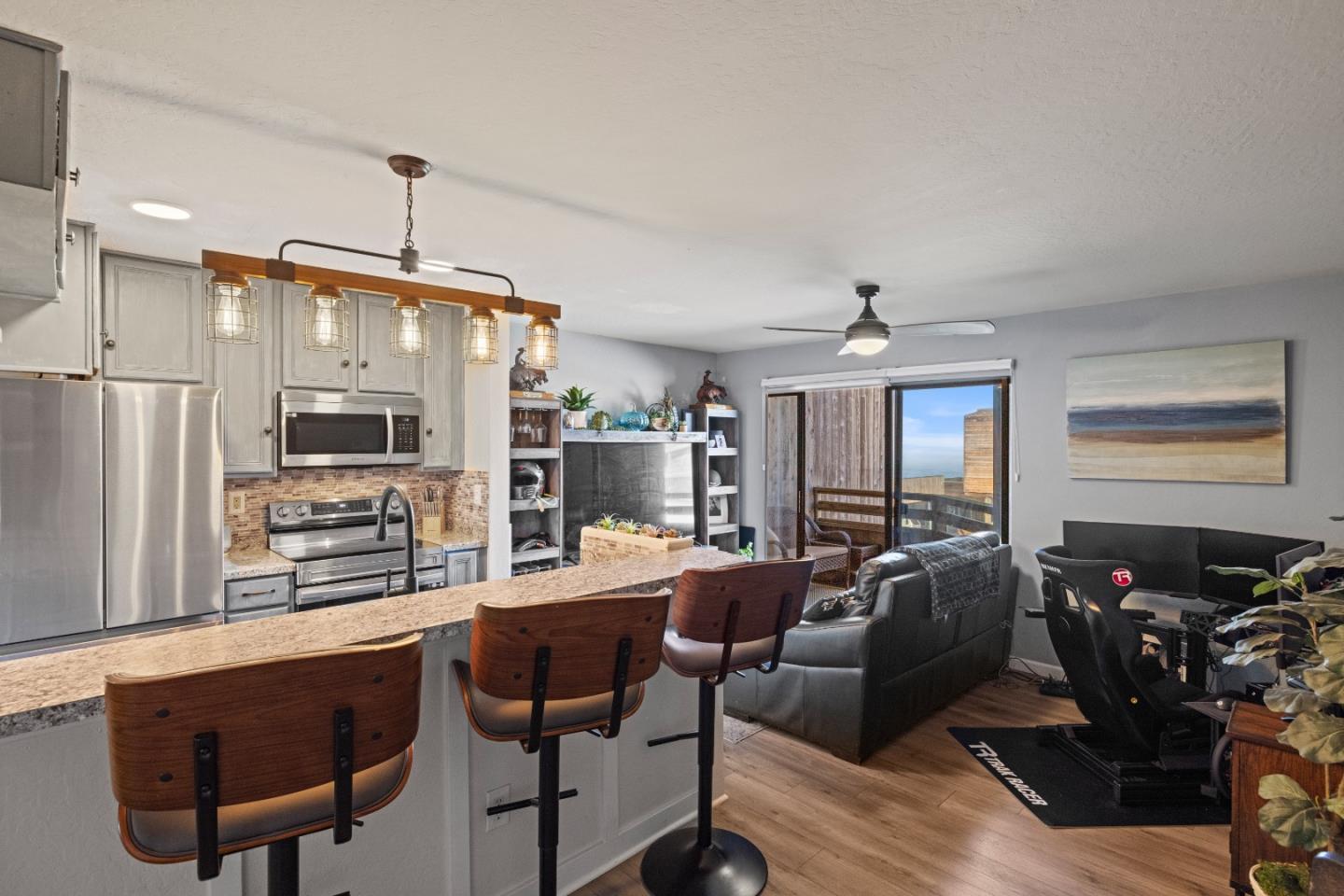 125 Surf Way, Unit 305 Monterey, CA 93940 - Photo 5 of 27 a very nice looking living room with a large window and stainless steel appliances