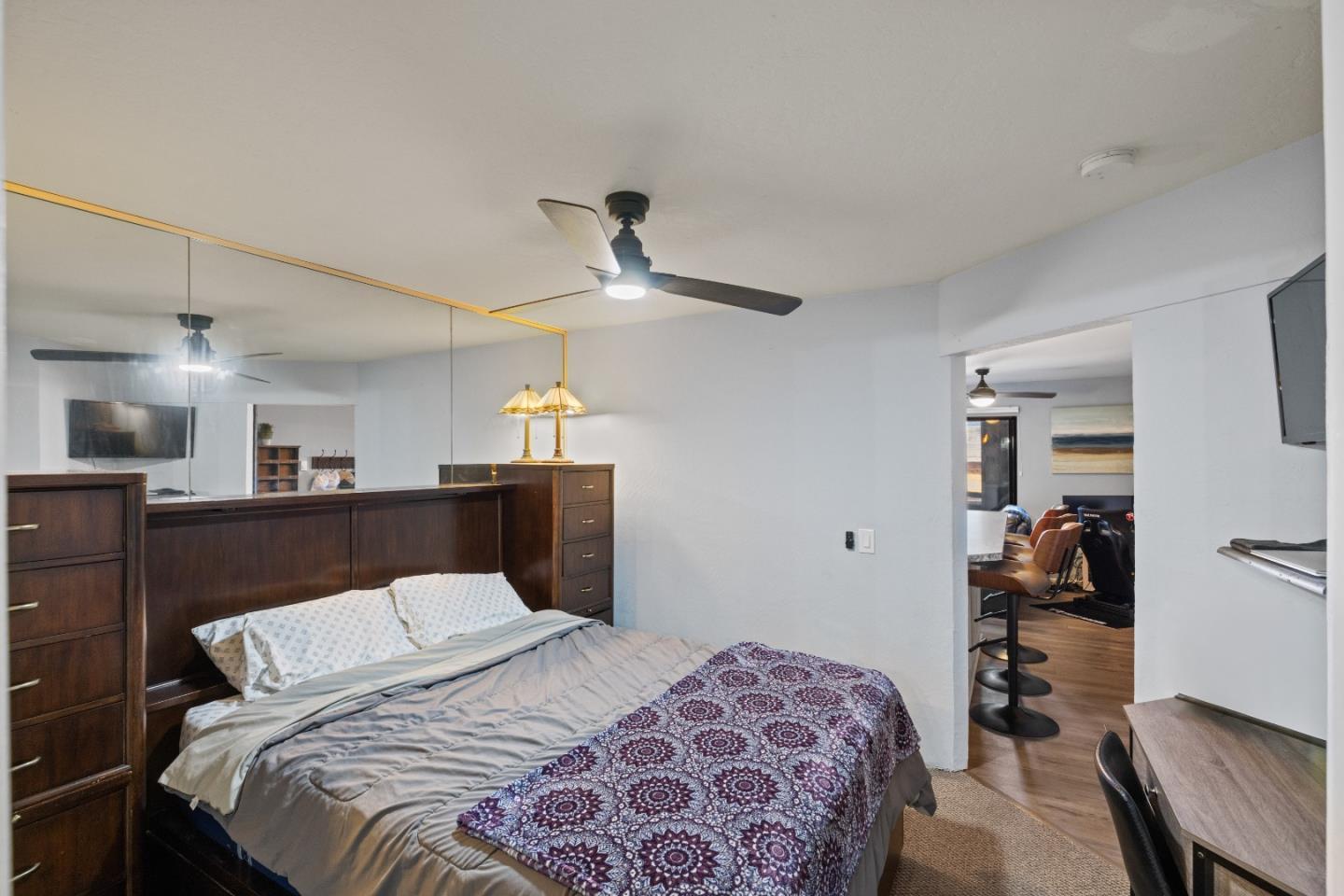 125 Surf Way, Unit 305 Monterey, CA 93940 - Photo 9 of 27 a bedroom with a large bed and a chandelier