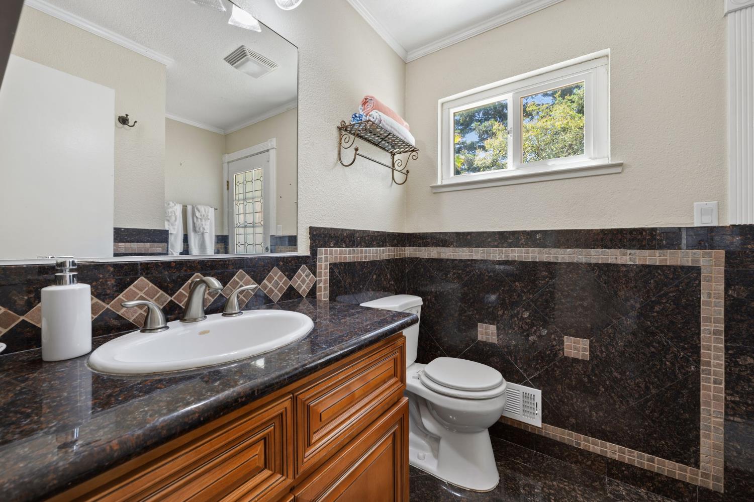 4206 Zephyr Way Sacramento, CA 95821 - Photo 17 of 45 a bathroom with a toilet sink and mirror