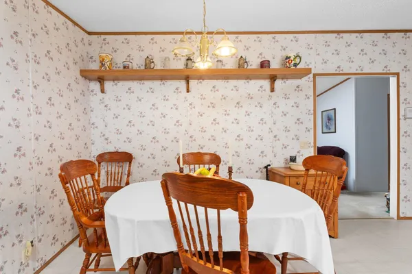 a view of a dinning room with furniture and wooden floor