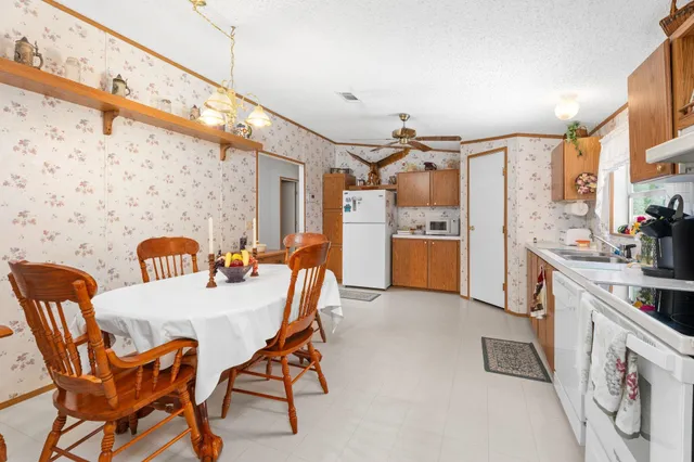 a view of a kitchen with furniture and wooden floor