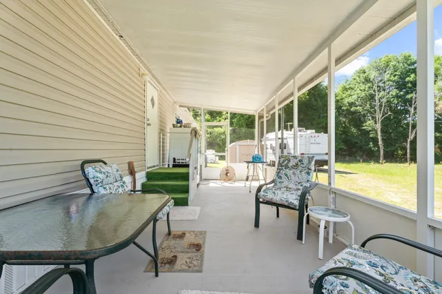 a balcony with furniture and a large window