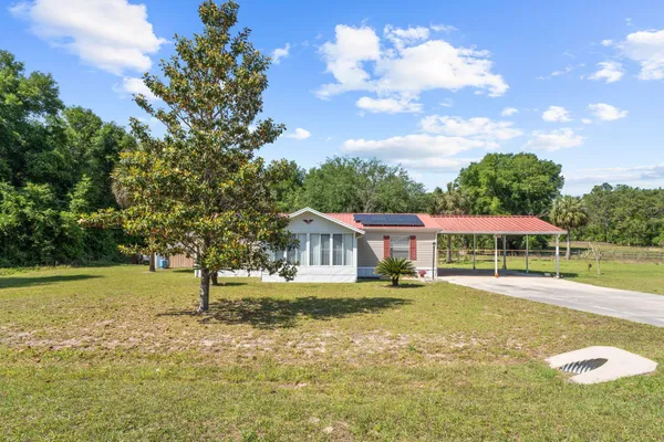 a house with swimming pool in front of it