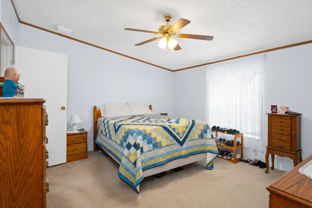 a bedroom with a bed and a chandelier