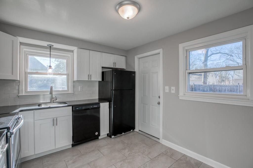 71 Peach Street Springfield, MA 01109 - Photo 3 of 21 a kitchen with a sink a refrigerator and window