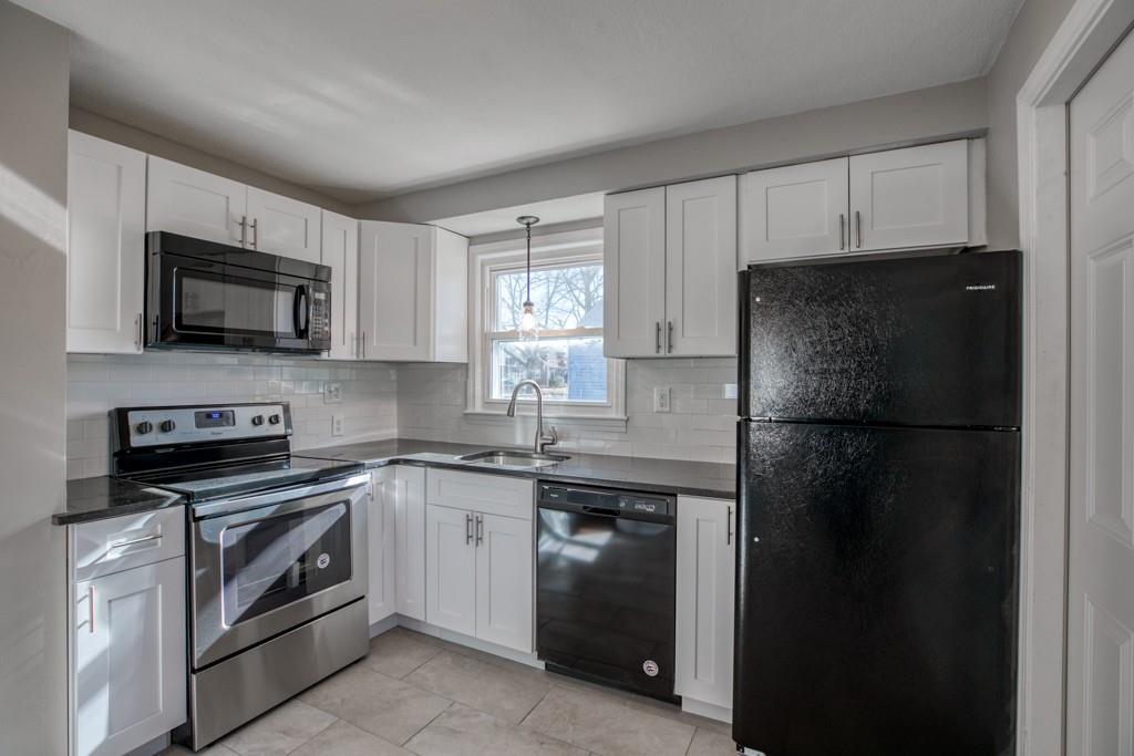71 Peach Street Springfield, MA 01109 - Photo 4 of 21 a kitchen with a sink stove and refrigerator