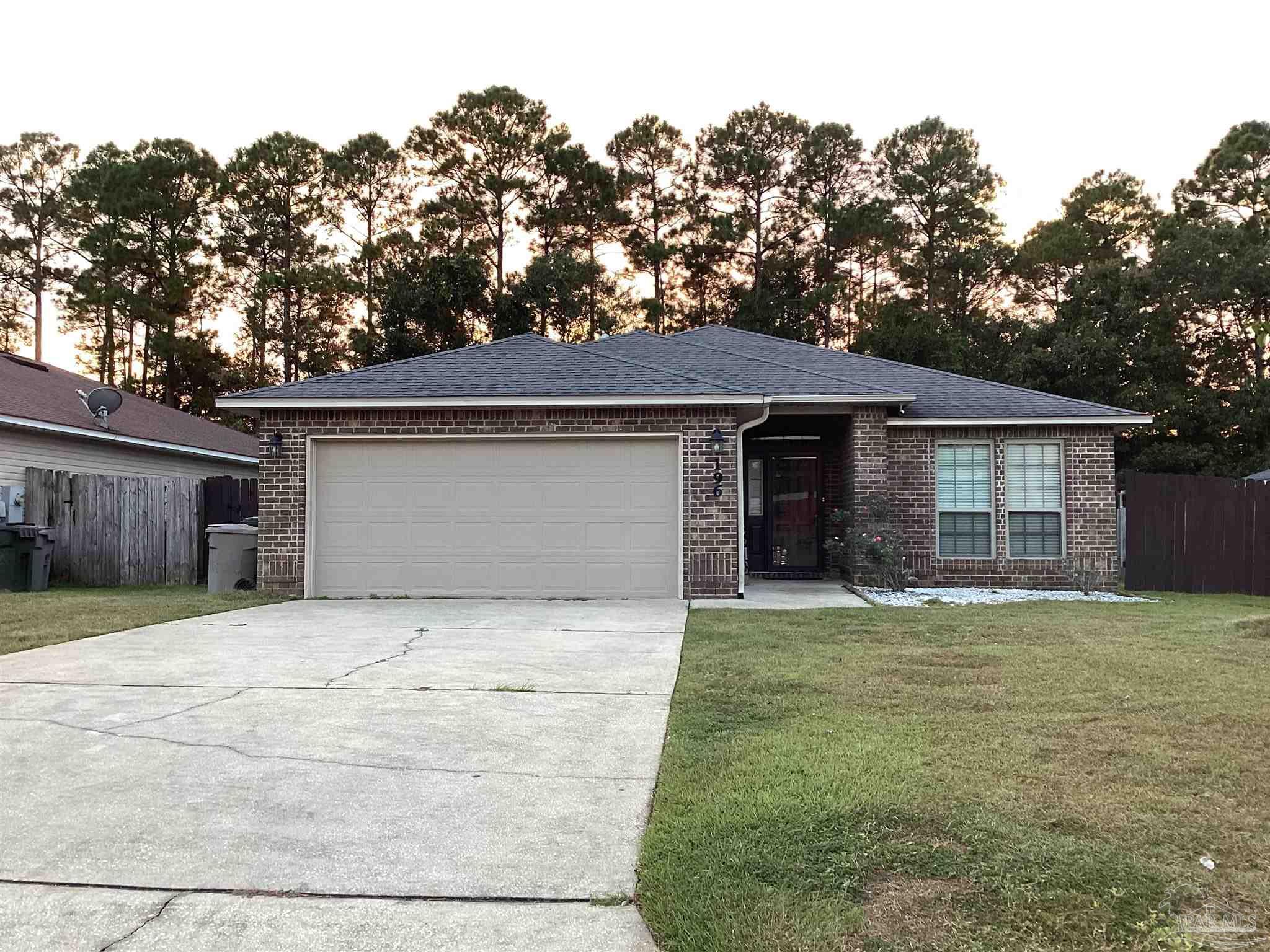 196 Millet Circle Cantonment, FL 32533 - Photo 1 of 20 a front view of a house with a yard and garage