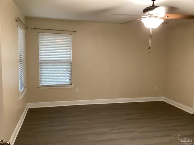 a large kitchen with stainless steel appliances wooden cabinets and a counter top space