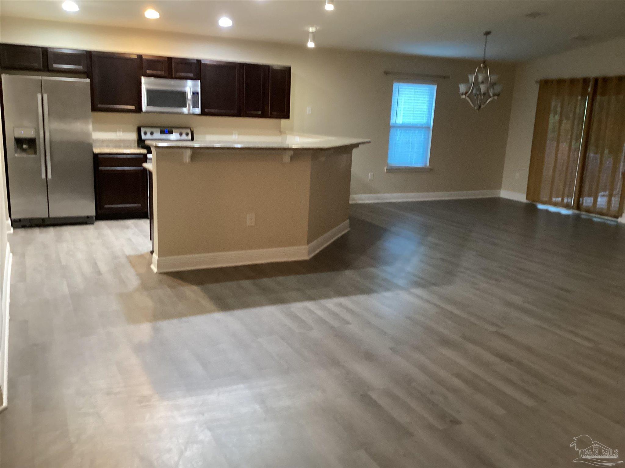196 Millet Circle Cantonment, FL 32533 - Photo 17 of 20 a large kitchen with stainless steel appliances wooden cabinets and a counter top space