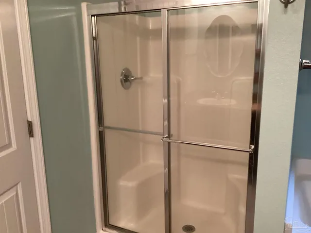 a bathroom with a glass shower door
