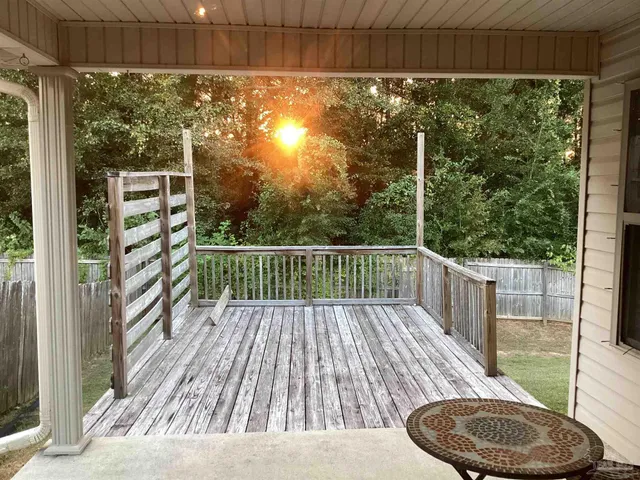 a view of balcony with table and chairs